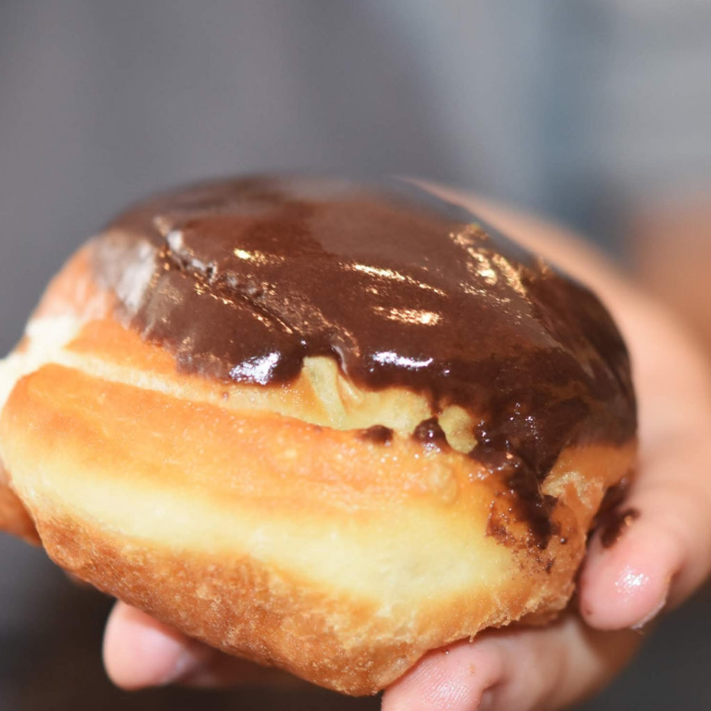 Homemade cream filled doughnut topped with chocolate icing. 