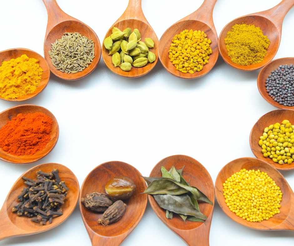 Indian spices in wooden spoons