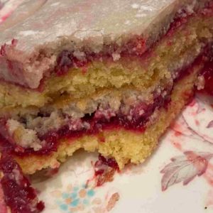 vanilla layer cake with raspberry coulis and french buttercream