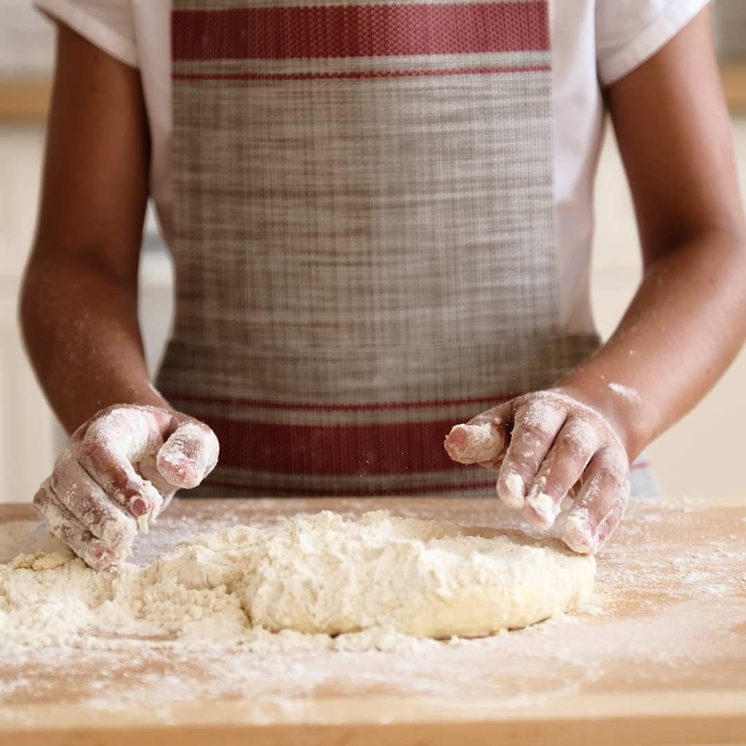 image of girl rolling biscuit dough