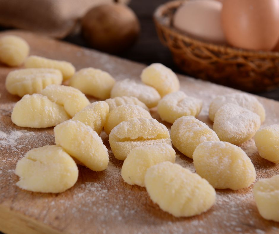 hand-rolled potato gnocchi on a wooden cutting board
