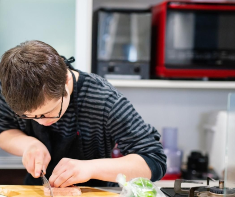 Neuro-divergent young adult preparing food